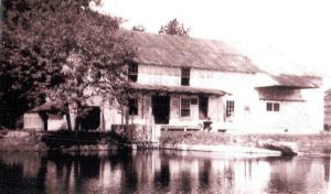 This picture of Double Mills, was taken from the Mill pond in the 1960s and was used as the Christmas card by Sherman Cooper, last full-time miller at Double Mills. (Photo credit: Double Mills website)
